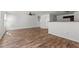 An open concept living room features luxury vinyl plank flooring leading to the kitchen area at 3816 Mike Levi Ct, Raleigh, NC 27610