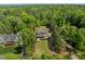 An aerial view shows a well manicured lawn and landscaped front yard surrounded by mature trees at 3913 Orchard Point Ct, Apex, NC 27539