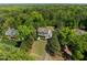 An aerial view shows a well manicured lawn and landscaped front yard surrounded by mature trees at 3913 Orchard Point Ct, Apex, NC 27539