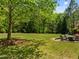 Serene backyard features a manicured lawn and patio area perfect for relaxing and enjoying the outdoors at 3913 Orchard Point Ct, Apex, NC 27539