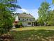 Sprawling backyard features an exterior elevation with lush lawn, landscaping, and a patio for outdoor enjoyment at 3913 Orchard Point Ct, Apex, NC 27539