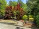 A backyard walkway and bench provides access to colorful foliage, shrubbery, and a gate at 3913 Orchard Point Ct, Apex, NC 27539