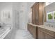 Primary bathroom featuring double vanity, soaking tub, and walk-in shower at 3913 Orchard Point Ct, Apex, NC 27539