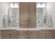 Bathroom vanity with double sinks, marble countertop, and custom wood cabinetry at 3913 Orchard Point Ct, Apex, NC 27539