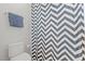 Bathroom with a toilet and a shower curtain with a geometric design at 3913 Orchard Point Ct, Apex, NC 27539