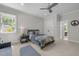 Spacious bedroom with neutral tones, plush carpeting, and ceiling fan at 3913 Orchard Point Ct, Apex, NC 27539