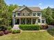 Charming two-story home featuring a stone facade, covered porch, and well-maintained landscaping at 3913 Orchard Point Ct, Apex, NC 27539
