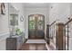 Welcoming foyer featuring hardwood floors, a staircase, and a decorative console table at 3913 Orchard Point Ct, Apex, NC 27539