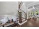 Foyer with hardwood floors, staircase, and a stylish bench creating a welcoming entrance at 3913 Orchard Point Ct, Apex, NC 27539