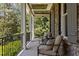 Inviting front porch with comfortable seating, stone columns, and a serene outdoor ambiance at 3913 Orchard Point Ct, Apex, NC 27539
