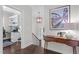 Hallway with hardwood floors, console table, and art at 3913 Orchard Point Ct, Apex, NC 27539