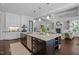 A gourmet kitchen with a large island flows seamlessly into the living area of this open-concept home at 3913 Orchard Point Ct, Apex, NC 27539