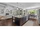 The open kitchen island connects the spaces of the living room and dining room in this comfortable home at 3913 Orchard Point Ct, Apex, NC 27539