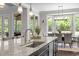 Bright kitchen with large island with bar seating and backyard views at 3913 Orchard Point Ct, Apex, NC 27539