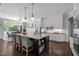 An open-concept kitchen features a large island with seating and dining space, and stainless appliances at 3913 Orchard Point Ct, Apex, NC 27539