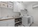Well-lit laundry room with utility sink, built in storage, and modern appliances at 3913 Orchard Point Ct, Apex, NC 27539