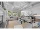 Bright living room features coffered ceilings, hardwood floors, and flows into kitchen and dining area at 3913 Orchard Point Ct, Apex, NC 27539