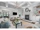 Bright living room with coffered ceilings, fireplace, built-in shelves, and stylish furniture at 3913 Orchard Point Ct, Apex, NC 27539