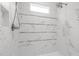 Walk-in shower featuring marble tile, a built-in seat, and glass enclosure at 3913 Orchard Point Ct, Apex, NC 27539