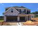 Exterior of a two-story home under construction, featuring a spacious open garage and classic architectural details at 40 Accord Dr, Youngsville, NC 27596