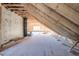 Spacious unfinished attic area with wood framing, insulation, window, and ample potential at 4009 Yates Mill Pond Rd, Raleigh, NC 27606
