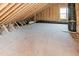 Unfinished attic space with wooden beams, window, and black insulated ductwork awaiting customization at 4009 Yates Mill Pond Rd, Raleigh, NC 27606