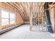 Bright, unfinished attic featuring wooden framing, a window and insulation, ready for conversion at 4009 Yates Mill Pond Rd, Raleigh, NC 27606