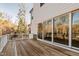 Spacious wooden back deck with white railings and large sliding glass doors with wooded views beyond at 4009 Yates Mill Pond Rd, Raleigh, NC 27606