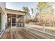 Exterior of a home featuring a wooden deck and screened in porch with white railings at 4009 Yates Mill Pond Rd, Raleigh, NC 27606