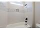 Bathroom with a soaking tub and modern shower head with tile accents at 4009 Yates Mill Pond Rd, Raleigh, NC 27606