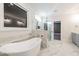 Bright bathroom featuring a modern soaking tub and a frameless glass shower at 4009 Yates Mill Pond Rd, Raleigh, NC 27606