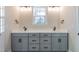 Bright bathroom featuring a double vanity, modern fixtures, and a large window offering natural light at 4009 Yates Mill Pond Rd, Raleigh, NC 27606