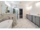 Bright bathroom featuring a modern soaking tub, walk-in shower, and double vanity at 4009 Yates Mill Pond Rd, Raleigh, NC 27606