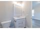 Bathroom featuring a white vanity, toilet, frameless mirror, and neutral wall paint at 4009 Yates Mill Pond Rd, Raleigh, NC 27606