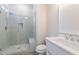 Bathroom with tiled walk-in shower featuring a frameless glass door, seat, niche, and modern fixtures at 4009 Yates Mill Pond Rd, Raleigh, NC 27606