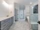 Bathroom with marble tile floors, glass shower, and double vanity at 4009 Yates Mill Pond Rd, Raleigh, NC 27606