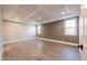 Bedroom with coffered ceiling, wood floors, and two windows at 4009 Yates Mill Pond Rd, Raleigh, NC 27606