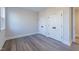 Well-lit bedroom with spacious double closets and wood-look floors at 4009 Yates Mill Pond Rd, Raleigh, NC 27606