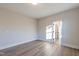 Bright bedroom features beautiful wood floors and a doorway to another room at 4009 Yates Mill Pond Rd, Raleigh, NC 27606