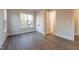 Bedroom featuring a window, closet with double doors, hardwood floors, and neutral paint color at 4009 Yates Mill Pond Rd, Raleigh, NC 27606