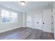 Bedroom with wood floors, a window, and two doors leading to closets at 4009 Yates Mill Pond Rd, Raleigh, NC 27606