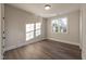 Bedroom featuring hardwood floors, neutral paint, window providing ample natural light, and white trim at 4009 Yates Mill Pond Rd, Raleigh, NC 27606