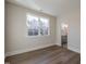 Bedroom bathed in natural light with hard surface floors and ensuite bath at 4009 Yates Mill Pond Rd, Raleigh, NC 27606