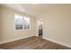 Bedroom featuring hardwood floors, neutral paint, window, and an adjoining bathroom at 4009 Yates Mill Pond Rd, Raleigh, NC 27606