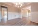 Spacious dining room with chandelier, wainscoting and hardwood floors at 4009 Yates Mill Pond Rd, Raleigh, NC 27606