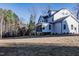 Expansive lawn and a home with a screened porch and multiple windows at 4009 Yates Mill Pond Rd, Raleigh, NC 27606