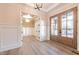 Foyer with hardwood floors, decorative molding and glass paneled french doors at 4009 Yates Mill Pond Rd, Raleigh, NC 27606