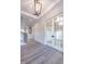 Elegant foyer with hardwood floors, staircase, and stylish pendant lighting at 4009 Yates Mill Pond Rd, Raleigh, NC 27606