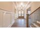 Inviting foyer with beautiful hardwood floors, staircase, and stylish light fixture at 4009 Yates Mill Pond Rd, Raleigh, NC 27606
