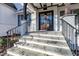 Inviting front entrance featuring stone steps, dark wood door, and black iron railings at 4009 Yates Mill Pond Rd, Raleigh, NC 27606